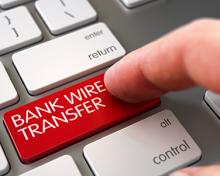 bank wire transfer on a computer keyboard